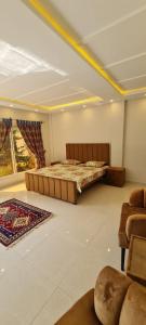a large room with two beds and a couch at Abbott royale farm in Abbottabad +7 photos