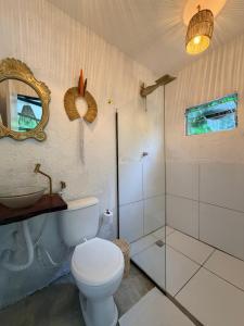 a bathroom with a toilet and a sink and a mirror at Studio Bali - Village Capixaba in Gravatá +12 photos