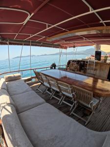 a boat with chairs and a table on the deck at Cakabey Yachting in Demre