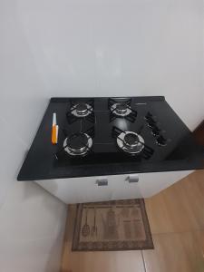 a black stove top oven in a kitchen at Studio Duplex Praia do Porto in Imbituba +43 photos