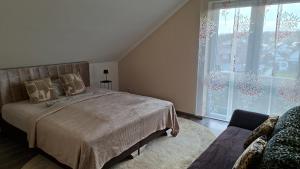a bedroom with a bed and a large window at Panorama Wohnung in Künzelsau