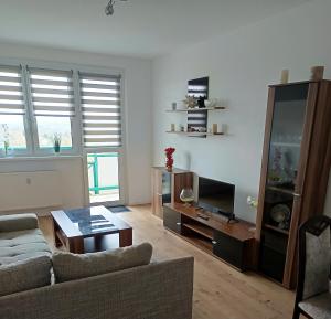 a living room with a couch and a table at Ferienwohnung Lea in Sangerhausen