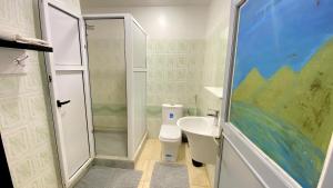 a bathroom with a shower and a toilet and a sink at RESIDENCE OUARZAZATE in Ouarzazate +20 photos