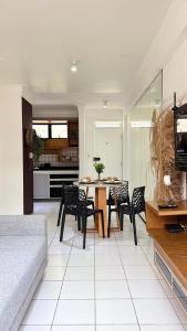 a living room with a table and chairs at (103) Coastal seaside - Pebble in Pimenta