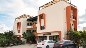two cars parked in front of a building at SUITES LOMBOY & PLAZA in San José del Cabo