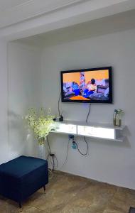 a living room with a tv on a wall at Studio meublé akwa in Douala