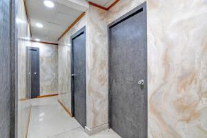 a corridor with two doors in a building at Hotel O Jalan Regency in Kolkata