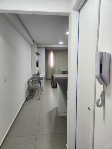a hospital hallway with a bed and a phone at West Fit Padrão 05 in Mossoró +4 photos