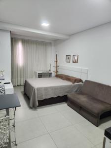 a bedroom with a bed and a couch at West Fit Padrão 05 in Mossoró