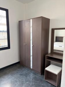 a room with a wardrobe and a mirror in it at SET Guesthouse 3 in Kata Beach