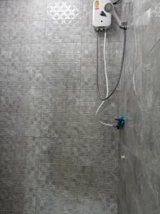a shower with a shower head in a bathroom at SET Guesthouse 3 in Kata Beach
