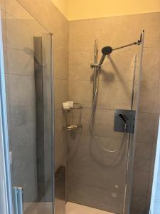 a shower with a glass door in a bathroom at Villa Perla in Battipaglia