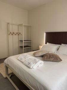 a bedroom with a large bed with towels on it at Villa Perla in Battipaglia