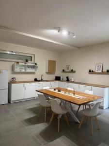 a large kitchen with a wooden table and chairs at Villa Perla in Battipaglia