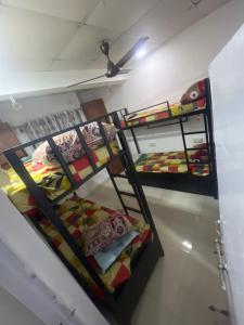 two bunk beds in a room with colorful sheets at BEYOND INFINITY GROUP, pg in Navi Mumbai