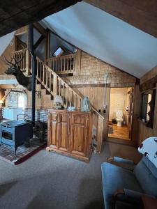 a living room with a staircase in a house at The Greenfield Inn in Greenfield