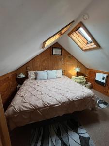 a bedroom with a large bed in a attic at The Greenfield Inn in Greenfield
