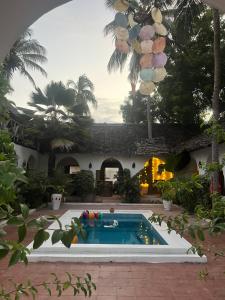 a swimming pool in front of a house at Kimulimuli Wellness Spa Hotel in Bwejuu +149 photos