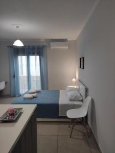 a bedroom with a bed and a chair in it at Varkaris Room 3 in Katarráktis