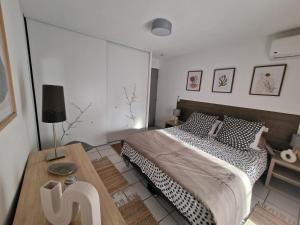 a bedroom with a bed and a wooden table at L'oasis bleu in Cerbère +68 photos