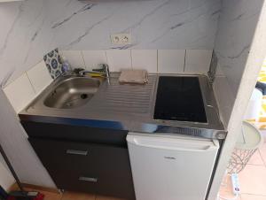 a small kitchen with a sink and a counter top at Le condo douillet d'Avignon in Avignon +5 photos