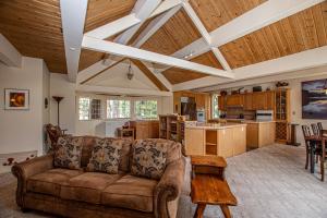 a living room with a couch and a kitchen at Trailside Escape By Hauserman Rentals in Tahoe City