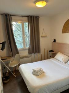a bedroom with a bed and a window at Hotel Au Bon Sejour in Vitry-le-François +32 photos