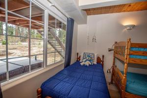 a bedroom with a bunk bed and a large window at Trailside Escape By Hauserman Rentals in Tahoe City