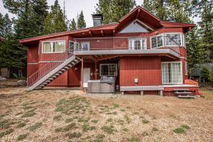 a red house with a staircase in a yard at Trailside Escape By Hauserman Rentals in Tahoe City