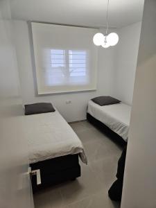 a bedroom with two beds and a window at Flamenca Village Resort apt 455 in Orihuela Costa +42 photos