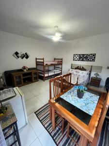 a living room with a table and a couch at Suíte aconchego in Cabo Frio