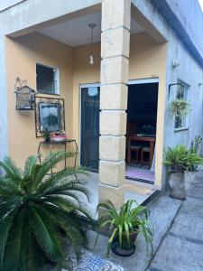 a house with some plants in front of it at Suíte aconchego in Cabo Frio +2 photos