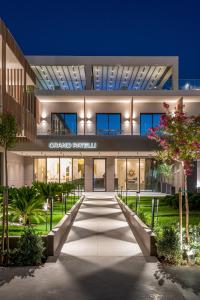 an external view of a building at night at GRAND PATELLI in Myrina