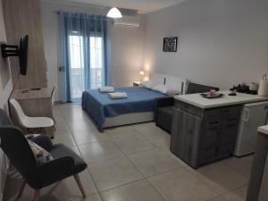 a living room with a bed and a kitchen and a kitchen at Varkaris Room 2 in Katarráktis