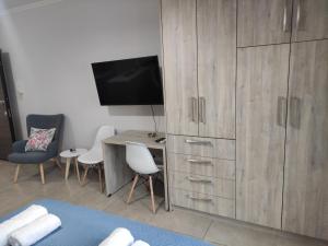 a bedroom with a desk and a large wooden cabinet at Varkaris Room 2 in Katarráktis