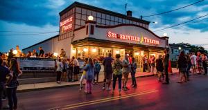 a crowd of people standing outside of a restaurant at The Washington House Hotel & Restaurant in Sellersville