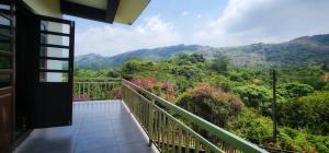 a balcony with a view of the mountains at Roca vista villaas vagamon in Vagamon