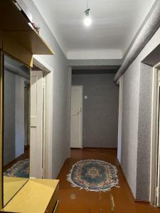 an empty room with a rug on the floor at Flat in mountains in Yangiobod