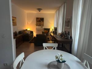 a dining room and living room with a table and chairs at Philosophen und Neckarblick Apartment in Heidelberg