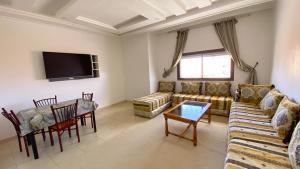 a living room with a couch and a table at RESIDENCE OUARZAZATE in Ouarzazate