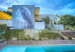 a building with a painting of a dolphin on it at Villa Los Laureles III, Private Pool, Nature Trails, Beaches in Esterillos Este