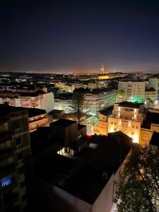 a view of a city at night with buildings at Studio Central na Amadora, Vista da Cidade, Sossegado, a 15min de Lisboa in Amadora