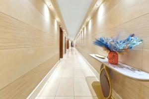 a hallway with a long hall with a vase at 250 SqM MEGA MANSION in London