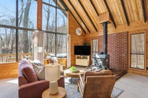 a living room filled with furniture and a fireplace at Dog-Friendly A-Frame with Hot Tub and Firepit in Hedgesville