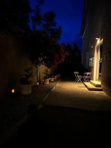 a dark room with a building and a table and a tree at Monkey Puzzle Apartment No1 in Bunclody +4 photos