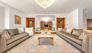 a living room with two couches and a coffee table at 250 SqM MEGA MANSION in London