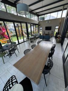 a large room with a large wooden table and chairs at The Zhen in Strand