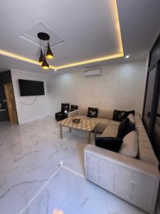 a living room with a couch and a table at Villa Piscine Jacuzzi Saïdia 3 chambres in Saïdia