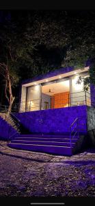 a purple building with stairs in front of it at night at Deluxe loft with direct access to the lagoon in Momoxpan