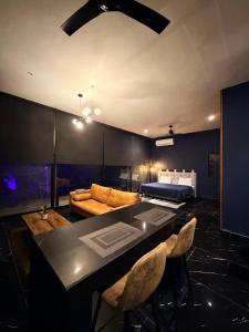 a living room with a bed and a table and chairs at Deluxe loft with direct access to the lagoon in Momoxpan